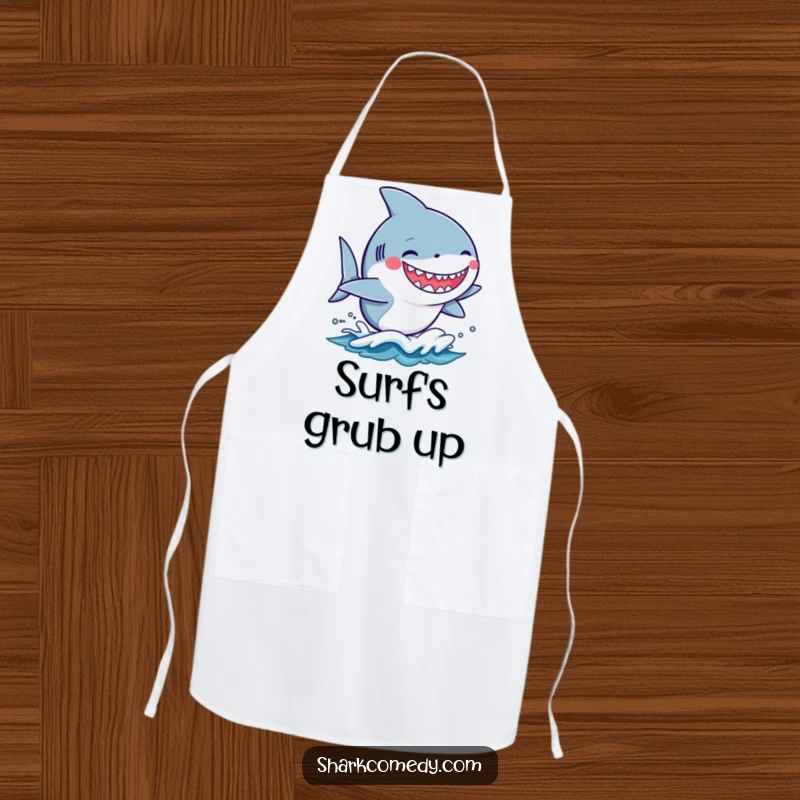 Funny kawaii shark with a silly grin riding a small wave on a kitchen apron, bringing humor to cooking.