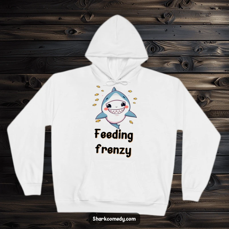 Funny hoodie featuring a kawaii shark with a wide grin, juggling tiny fish, perfect for cozy, playful moments.