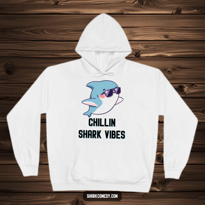 Funny kawaii shark wearing sunglasses doing a playful flip on a hoodie, perfect for staying warm with a dose of humor.