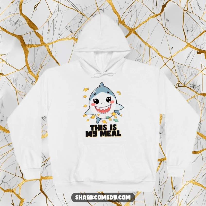 Funny hoodie featuring a kawaii shark with a wide grin juggling tiny fish, offering cozy comfort and a dose of charming humor.