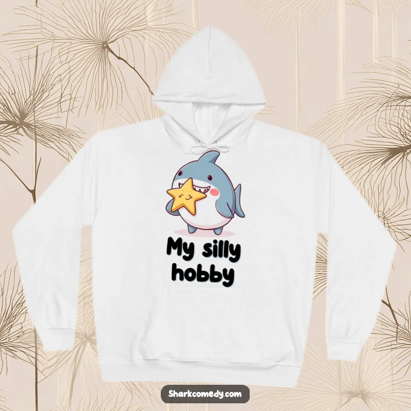 Funny chubby shark hoodie, adorably balancing a tiny smiling starfish on its nose, a warm and humorous piece of apparel for cute creature fans.