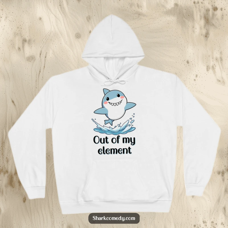 Funny hoodie featuring a little shark bursting from the water with an exaggerated surprised grin, full of energetic fun.