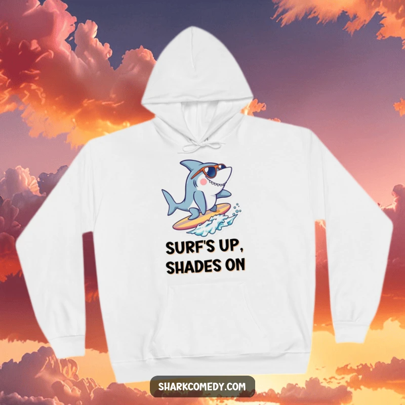 Funny cool shark hoodie featuring a shark with sunglasses surfing a tiny surfboard, perfect for cozy beach days and cool attitudes.