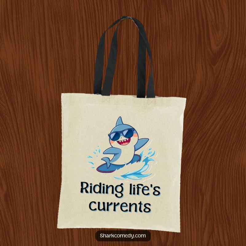 Funny tiny shark wearing sunglasses, joyfully surfing a blue wave, showcased on a durable and stylish tote bag.